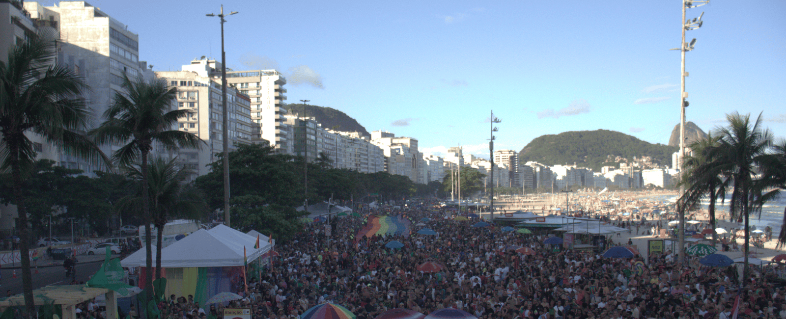 Multidão celebrando a Parada do Orgulho LGBTI+ na orla de Copacabana